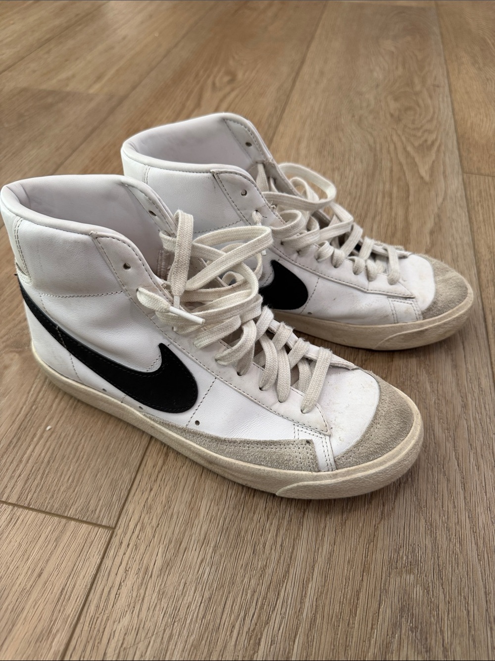 Nike White High-Top Sneakers with Black Swoosh